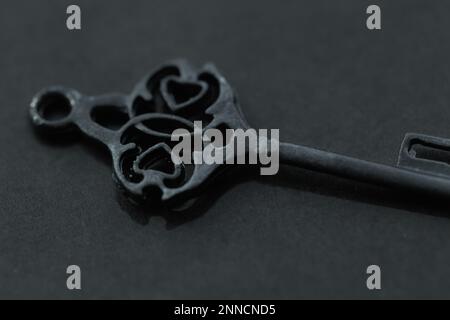 Close-up of an old antique key on a slate background. Stock Photo