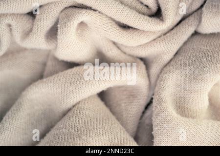 Knitted creamy background, beige sweater cozy pattern. Stock Photo