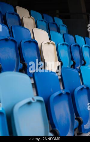 empty colorful seats on tribunes of stadium. Stock Photo