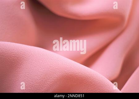 Delicate pale pink thin fabric, beige material chiffon waves. Stock Photo