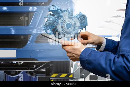 Serviceman repairing a car using augmented reality application Stock ...
