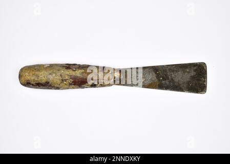 Close up of an old dirty palette knife, isolated on white background Stock Photo