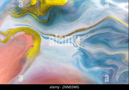 Colorful fluid art texture with blue, pink, and gold swirls creating vibrant modern abstract design. Stock Photo