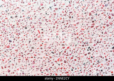 Pink terrazzo texture with scattered colorful stone chips, ideal for modern design and backgrounds. Stock Photo