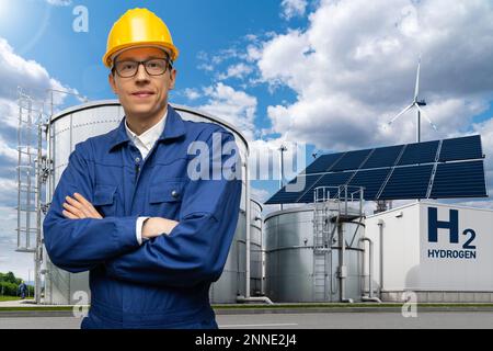 Engineer in helmet on a background of Hydrogen factory Stock Photo