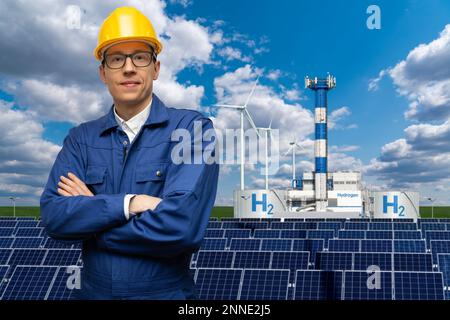 Engineer in helmet on a background of Hydrogen factory Stock Photo