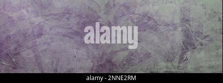 Textured purple plaster wall with abstract brush patterns, ideal background for artistic design projects. Stock Photo
