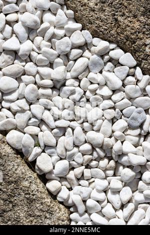Abstract composition formed by small white stones and granite rocks Stock Photo
