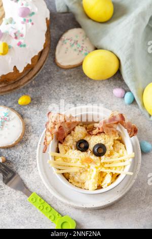 Easter breakfast idea. Scrambled eggs easter bunny on a stone background. Stock Photo