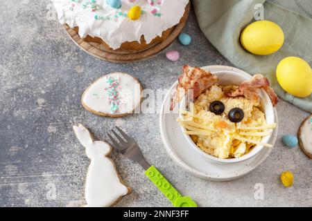 Scrambled eggs easter bunny on a stone background. Easter breakfast idea. Copy space. Stock Photo