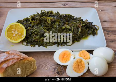 Greek Cuisine. Delicious Boiled dandelion. Horta or Wild Greens. Stock Photo