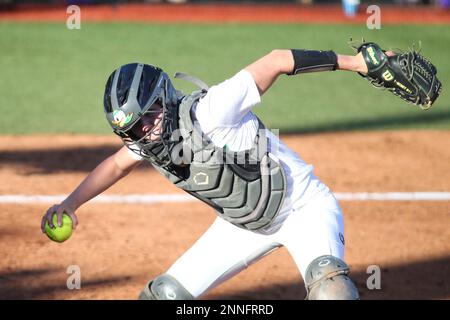 SEATTLE, WA - APRIL 17: Oregon Ducks catcher Terra McGowan (11) throws the  ball to first during a college softball game between the Oregon Ducks and  the Washington Huskies on April 17