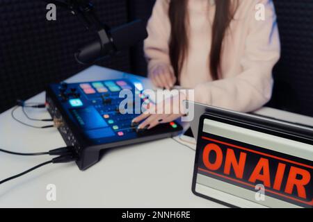 Crop woman using mixing console on table Stock Photo