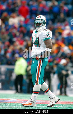 Miami Dolphins running back Ricky Williams (34) slides around Chicago Bears  linebacker Mike Caldwell (55) during the first half of the Monday, Dec. 9,  2002, game in Miami. (AP Photo/Gary I. Rothstein