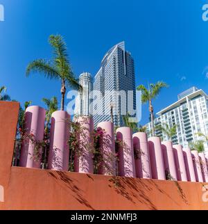 A picture of the U.S. Bank Tower and the Deloitte building or Gas Company Tower in Downtown Los Angeles as seen above a row of pink pillars. Stock Photo