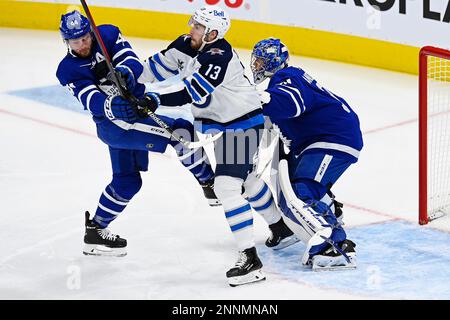 Winnipeg Jets center Pierre-Luc Dubois, top, puts Vancouver Canucks  defenseman Quinn Hughes (43) into the boards during second-period NHL  hockey game action in Vancouver, British Columbia, Sunday, Feb. 21, 2021.  (Jonathan Hayward/The