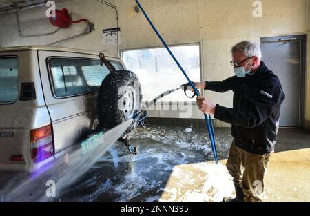 Sean Kirby from East Dover Vt. uses a sprayer wand to wash down