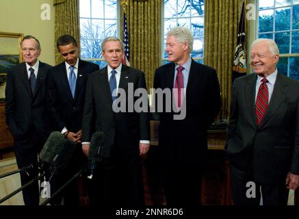 Washington, D.C. - January 7, 2009 -- United States President George W. Bush, center welcomes former United States President George H.W. Bush, left; United States President-elect Barack Obama, left center; former United States President Bill Clinton, right center; and former United States President Jimmy Carter, right; to the Oval Office of the White House in Washington, DC on Wednesday, January 7, 2009.  This was the first time all of the living past, present and future Presidents were at the White House together since 1981..Credit: Ron Sachs / Pool via CNP / MediaPunch Stock Photo