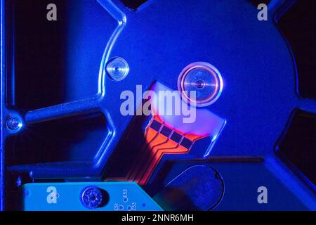 Close-up of blue external computer hard drive casing and orange data transferring electrical strips. Stock Photo