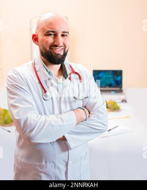 Smiling nutritionist doctor with crossed arms in her office. Portrait of smiling professional nutritionist, Portrait of smiling male nutritionist at Stock Photo