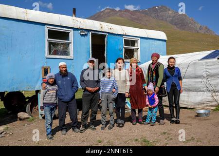Shepherd family in front of their caravan on their summer pasture, West Karakol Valley, Tien Shan Mountains, Naryn Region, Kyrgyzstan Stock Photo