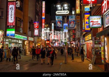 Street scene in the Shibuya district at night, Tokyo, Japan Stock Photo