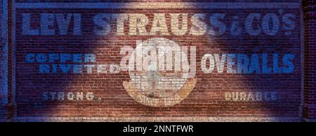Levi Strauss & Co vintage ad painted on brick wall Stock Photo