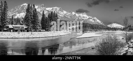 Black and white shot of house on Bow River bank in winter, Canmore, Alberta, Canada Stock Photo