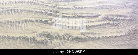 Sand patterns created by receding tide Stock Photo