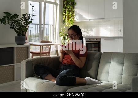 Immersed in web girl postponed things for later from social media addiction leisure time with phone. Stock Photo
