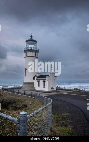 WA23064-00...WASHINGTON - Dawn, on a cloudy day,  at North Head Lighthouse overlooking the Pacific Ocean in Cape Disappointment State Park. Stock Photo