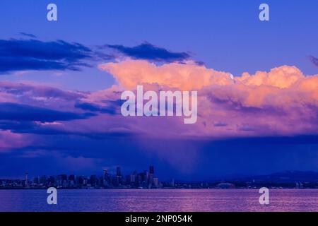 Pink clouds and full moon at sunset Stock Photo