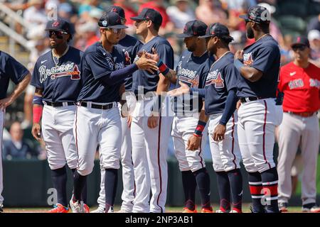 North Port FL USA: Atlanta Braves left fielder Eddie Rosario (8) shakes hands with teammates as the starting lineup is announced prior to an MLB sprin Stock Photo