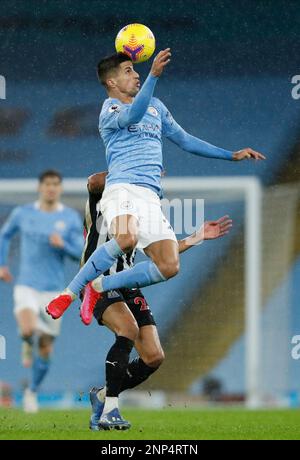 Manchester City's Joao Cancelo heads the ball during the Champions