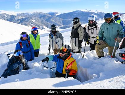 (230226) -- URUMQI, Feb. 26, 2023 (Xinhua) -- Peng Chao (down) introduces the characteristics of snow layers to skiers and rescue team members at a ski resort in Altay, northwest China's Xinjiang Uygur Autonomous Region on Jan. 13, 2023. With its high-quality snow conditions, Xinjiang in northwest China has built a number of high-standard ski resorts and become a new hotspot for winter sports. The snow season in Altay, which is located in the northernmost part of Xinjiang, can last up to seven months, making it a heaven for winter sports lovers. At the beginning of the snow season in 2021, Stock Photo