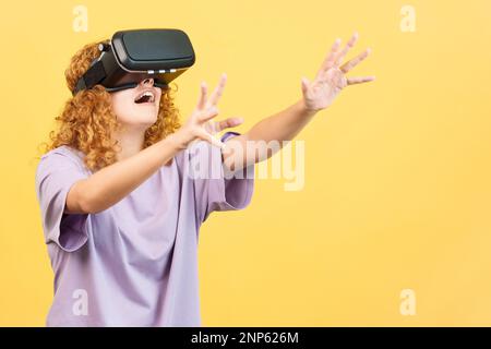 Woman gesturing while using a virtual reality goggles Stock Photo