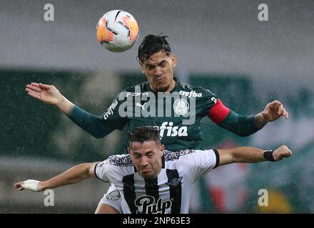 Gustavo Gomez of Brazil's Palmeiras heads the ball challenged by Carlos  Carmona of Chile's Colo Colo, right, during a quarter final second leg Copa Libertadores  soccer match in Sao Paulo, Brazil, Wednesday