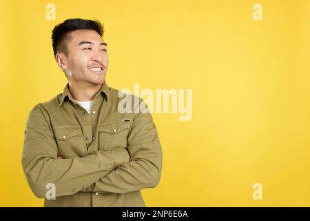 Chinese man smiling while looking to the side Stock Photo