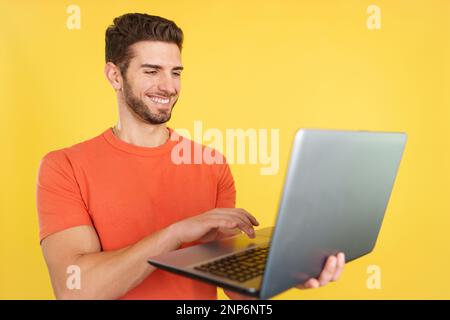 Caucasian man smiling while using a laptop Stock Photo