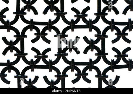 Close-up of a black painted wrought iron fence, isolated on white background, photography, Italy, Europe. Stock Photo
