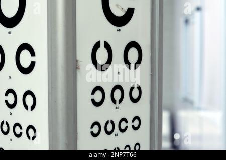 Landolt C broken ring optotypes or Japanese vision test in various sizes and orientations, an eye chart used for testing vision and visual acuity used Stock Photo