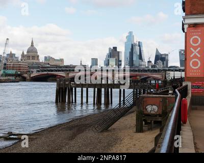 Beach on the south bank of the River Thames with Blackfriars Bridge, St Pauls Cathedral and Skyscrapers behind. London England Stock Photo