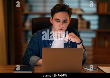 Young man project manager working late at office Stock Photo