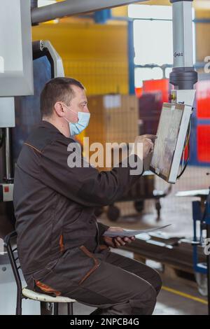 The operator tune a cnc machine at the factory Stock Photo