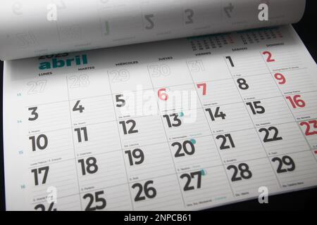 Close-up of a calendar sheet for the month of April in which the holy week, the saints' days and the lunar phases are indicated and in which each day Stock Photo