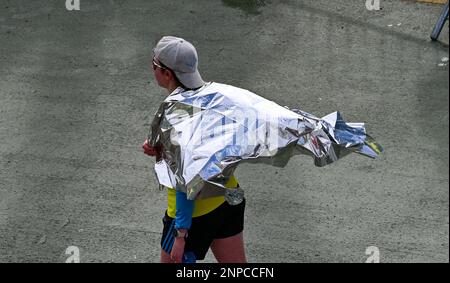 Brighton UK 26th February 2023 - Thousands of runners wearing foil blankets after taking part in the 33rd Brighton Half Marathon on a bright morning along the South Coast . Over ten thousand runners are expected to take part helping to raise money for various charities: Credit Simon Dack / Alamy Live News Stock Photo