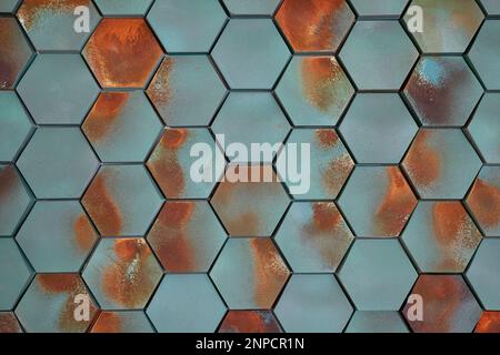 Hexagonal tiles in teal blue with rust-like orange marks, repeated pattern of six-sided polygons in shades of blue-green arranged in a uniform fashion Stock Photo