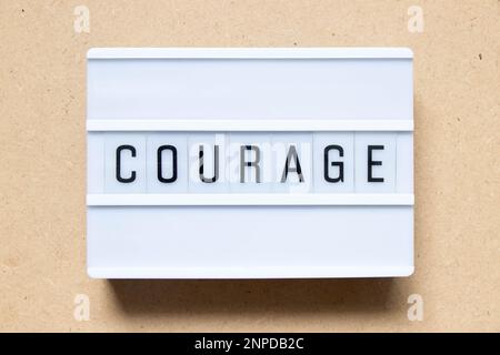 Lightbox with word courage on wood background Stock Photo