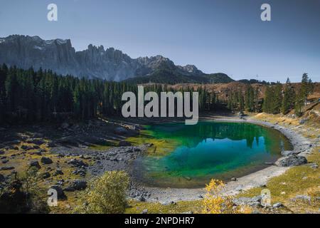 Lago di Carezza, also known as Lake Carezza or Karersee is one of the most beautiful lakes in the Dolomites region. It is known for its emerald green Stock Photo