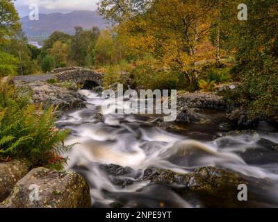 Water tumbling over rocks towards Ashness Bridge in the Lake District. Stock Photo